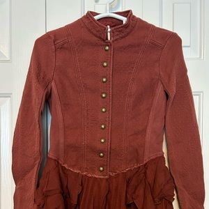 Free People Military Ruffles Jacket” front buttons Closure, long sleeves.
